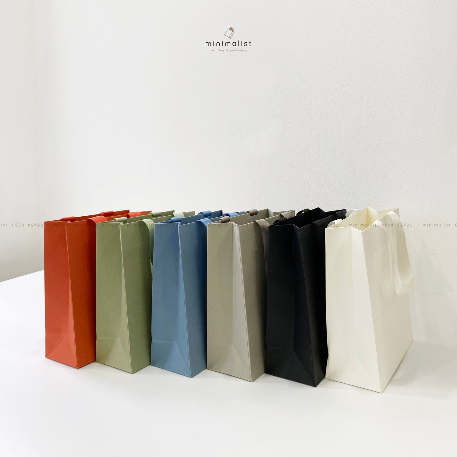 Paper bag with aesthetic glued ribbon handle