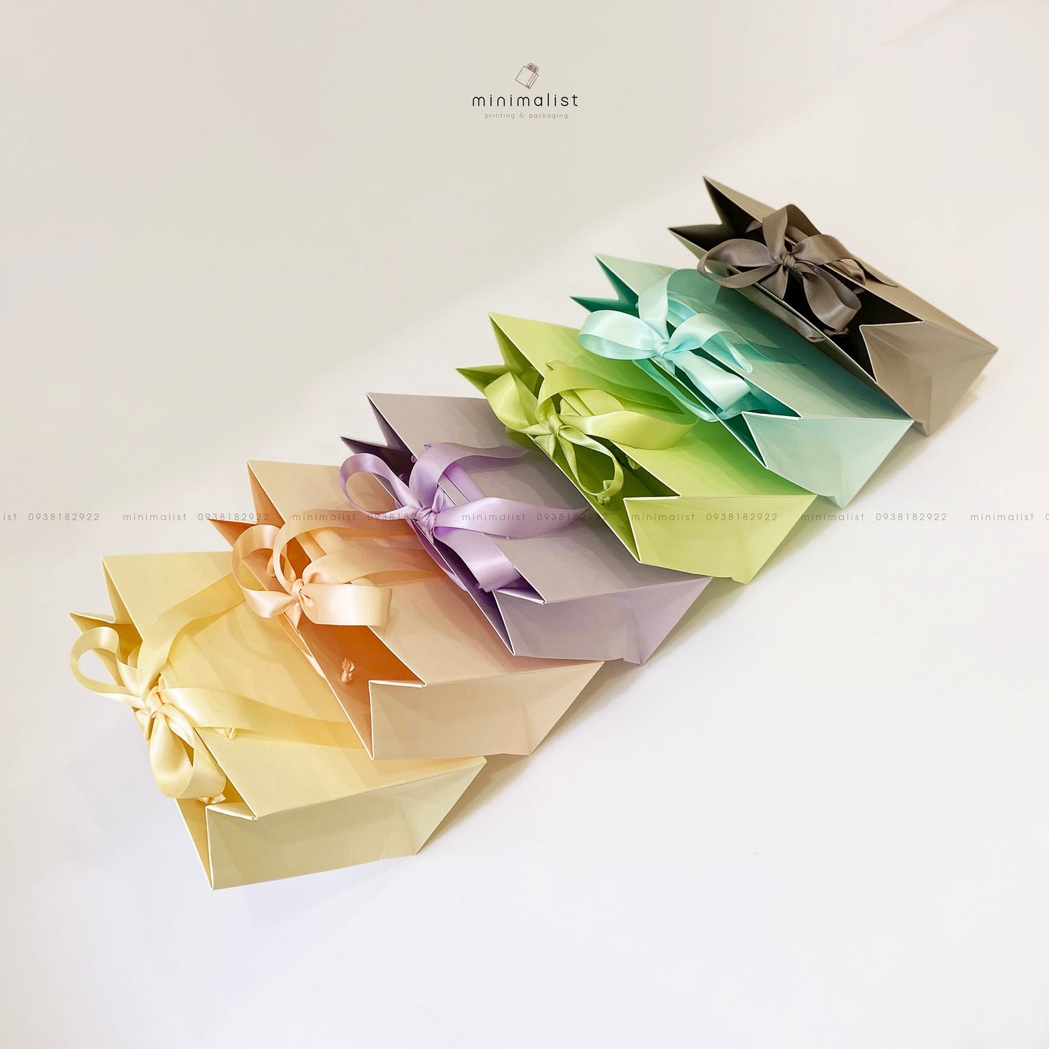 Perforated handle paper bag with satin ribbon
